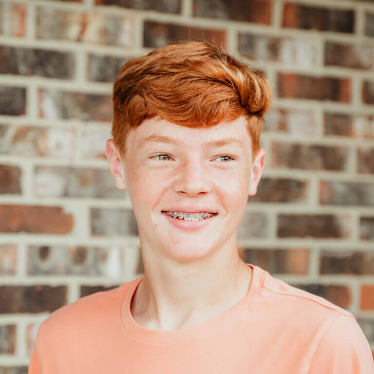 Teen boy with red hair and braces